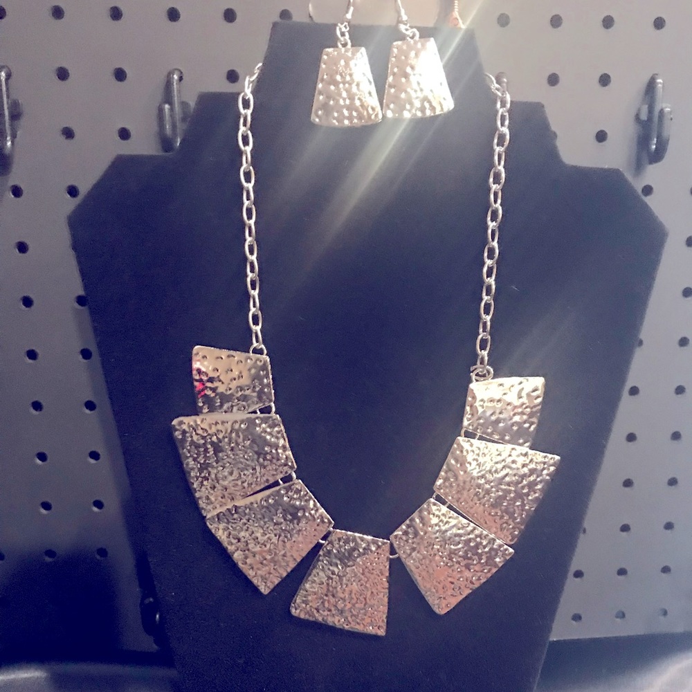 Beautiful silver necklace with matching earrings.